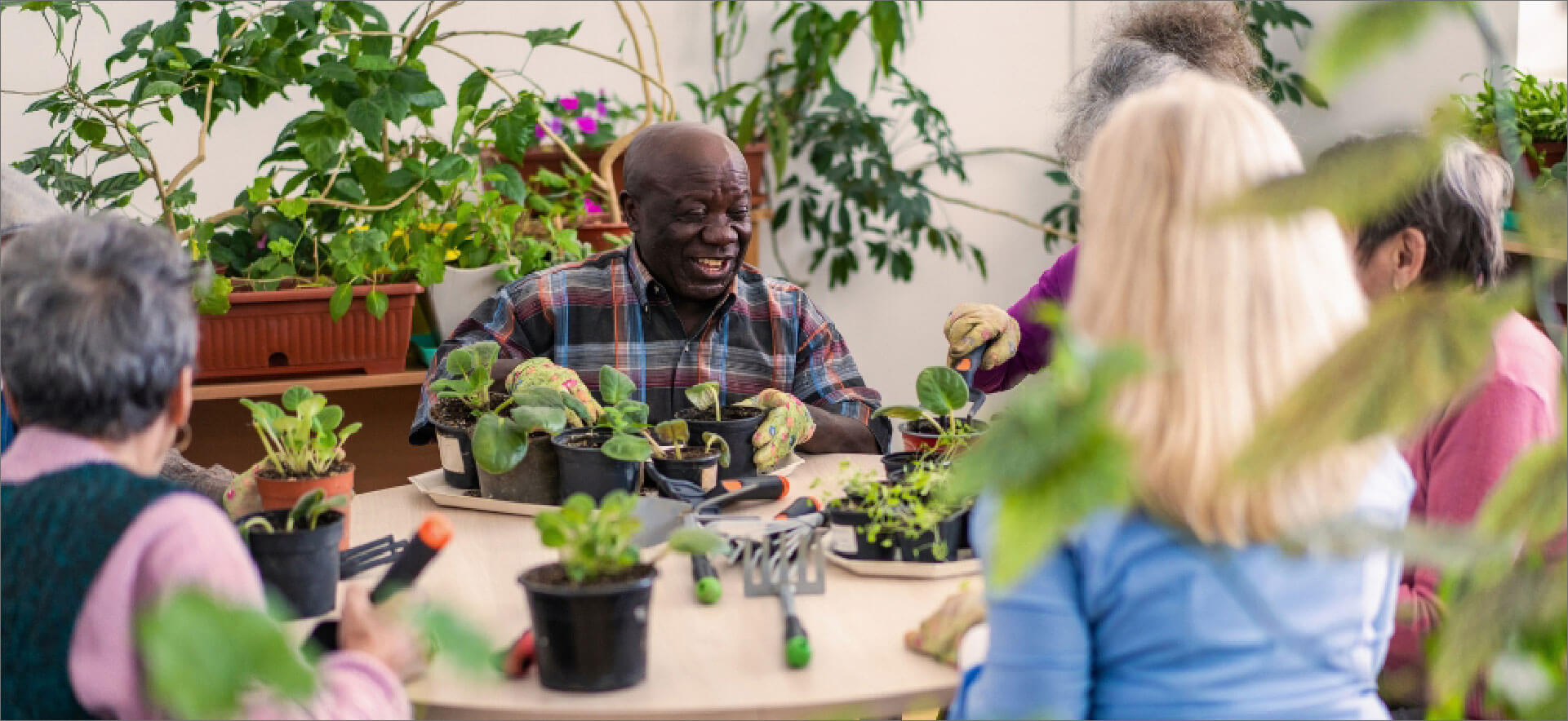 Elderly residents gardening together.
