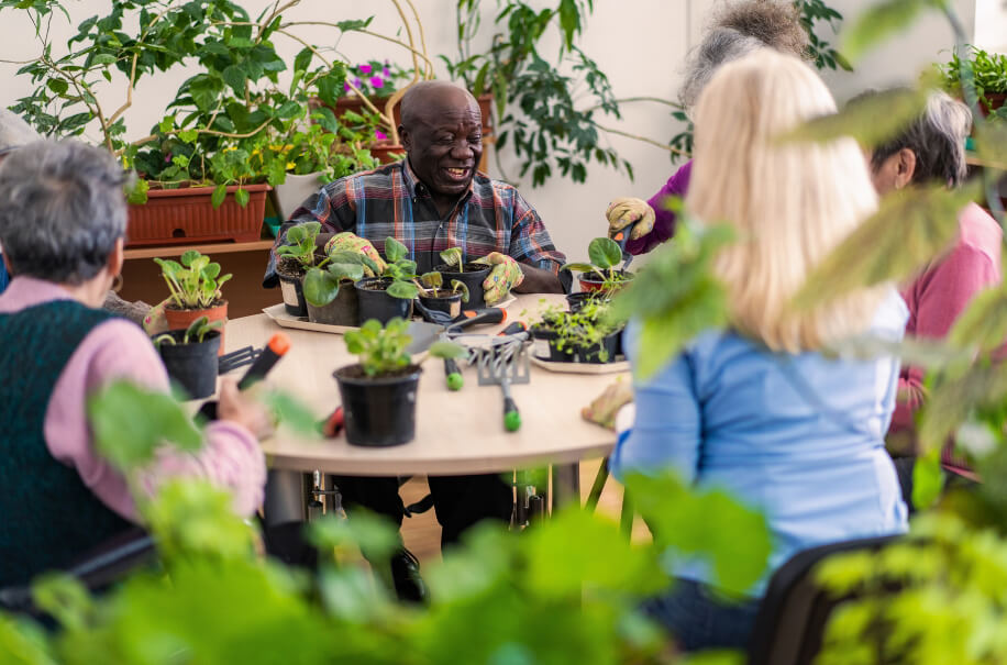 Elderly residents gardening together.