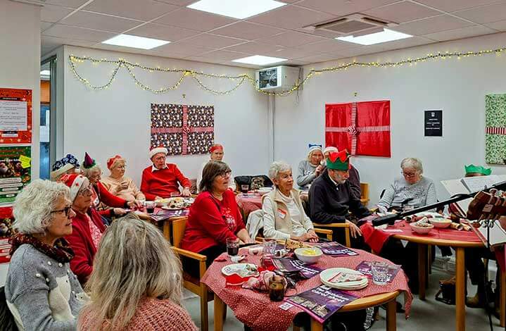people listening to music at a Christmas party
