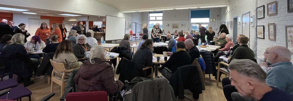 A busy room full of people networking in advance of the first West Sussex Dementia Network meeting