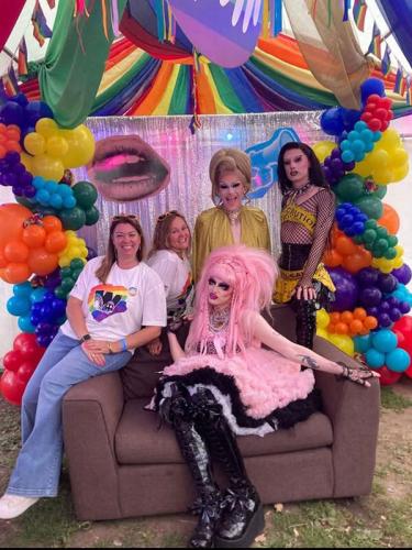Beehive Care staff at Worthing Pride taking a photo with drag queens