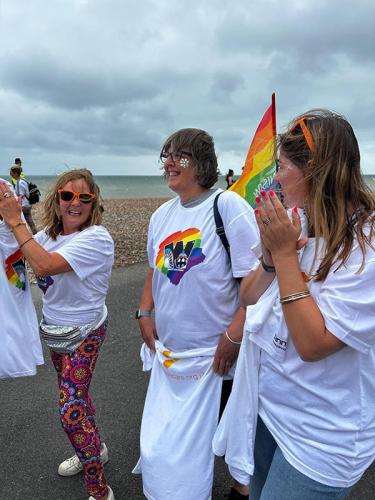 Beehive Care staff at Worthing Pride walking on Worthing beach